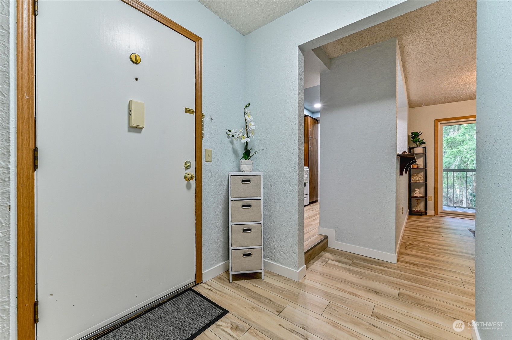 14401 Southeast Petrovitsky Road, Unit E105 Renton, WA 98058 - Photo 2 of 38 a view of livingroom with hardwood floor and hallway