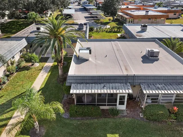 a room with lots of furniture and view of kitchen