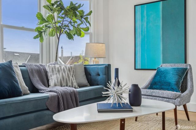 a living room with furniture and a potted plant