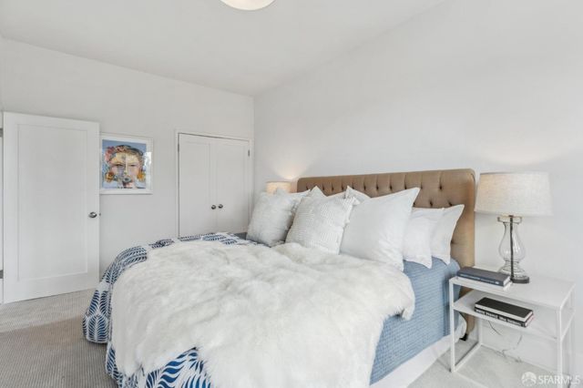 a large white bed in a white room