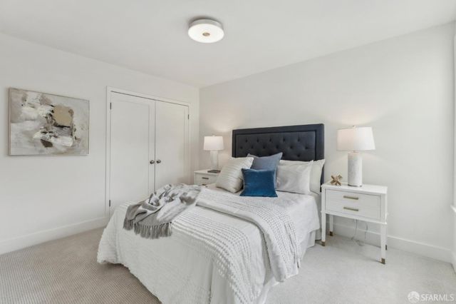 a bed room with a bed and a night stand