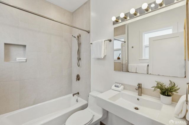 a bathroom with a sink toilet tub and shower