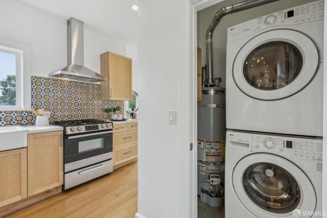 a kitchen with stove top oven and cabinets