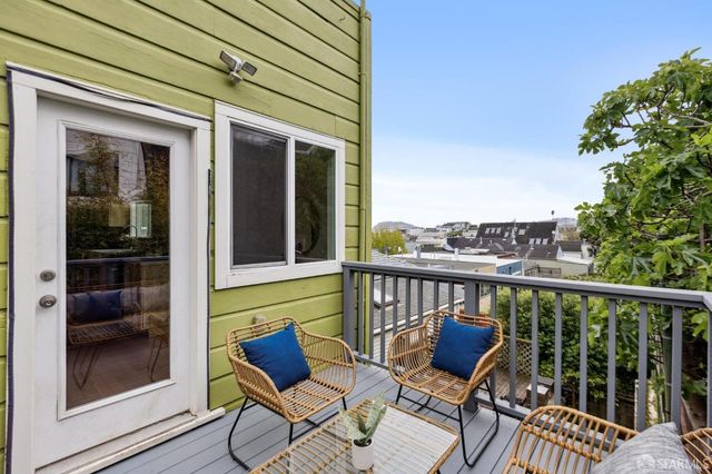 a view of a balcony with furniture