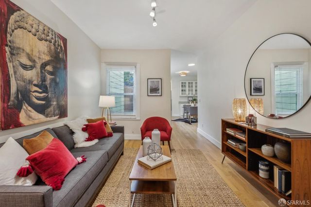 a living room with furniture and a mirror