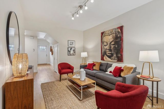 a living room with furniture a rug and a lamp