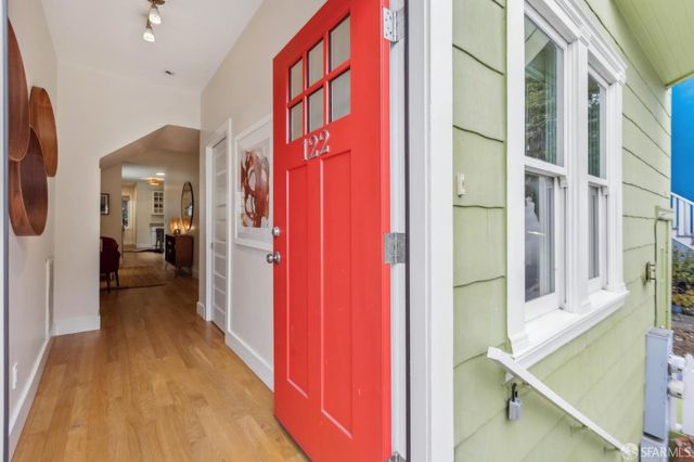 a view of hallway with furniture and a large window