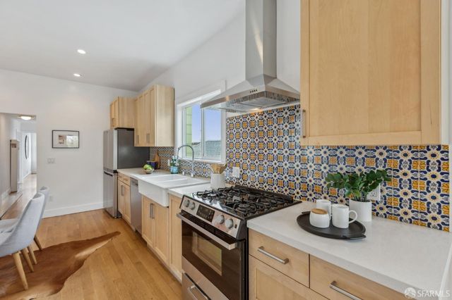 a kitchen with a sink stove and refrigerator