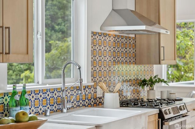 a bathroom with a bathtub and next to a window