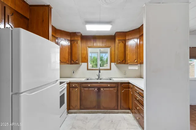 a kitchen with a sink stove and refrigerator