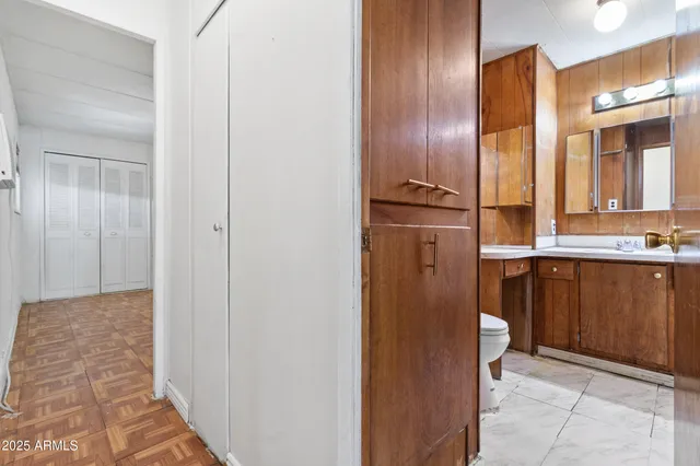 a view of a hallway with granite countertop cabinets