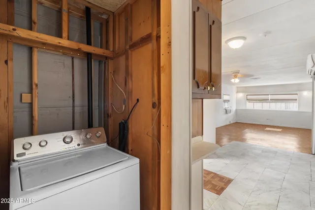 a view of washer and dryer with bathroom in the background