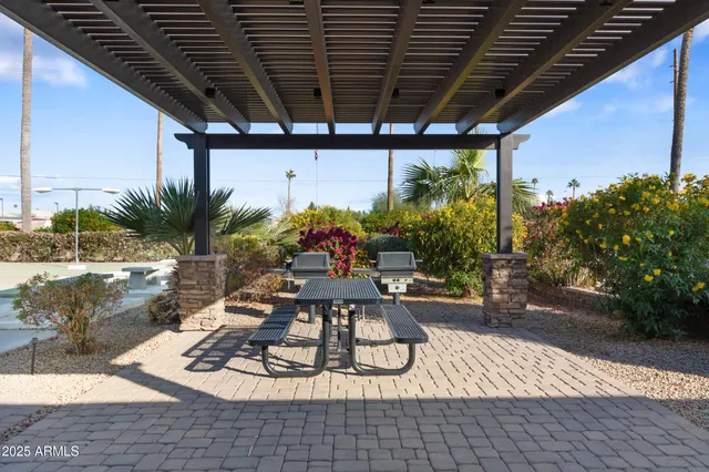 a view of a swimming pool with a table and chairs