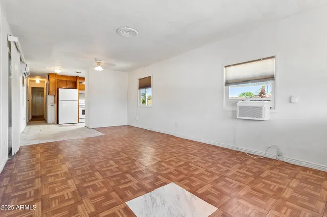 a view of empty room with wooden floor