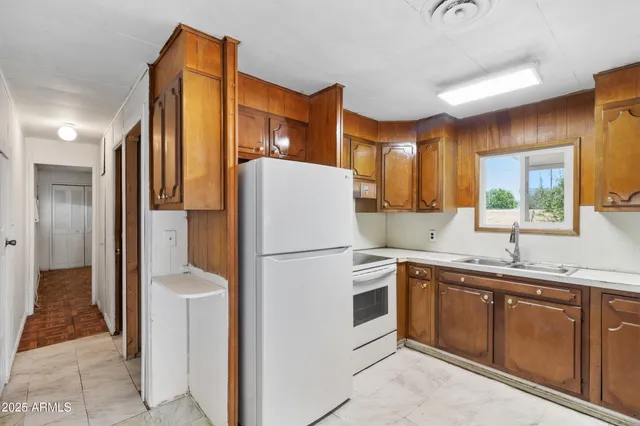 a white refrigerator freezer sitting inside of a kitchen