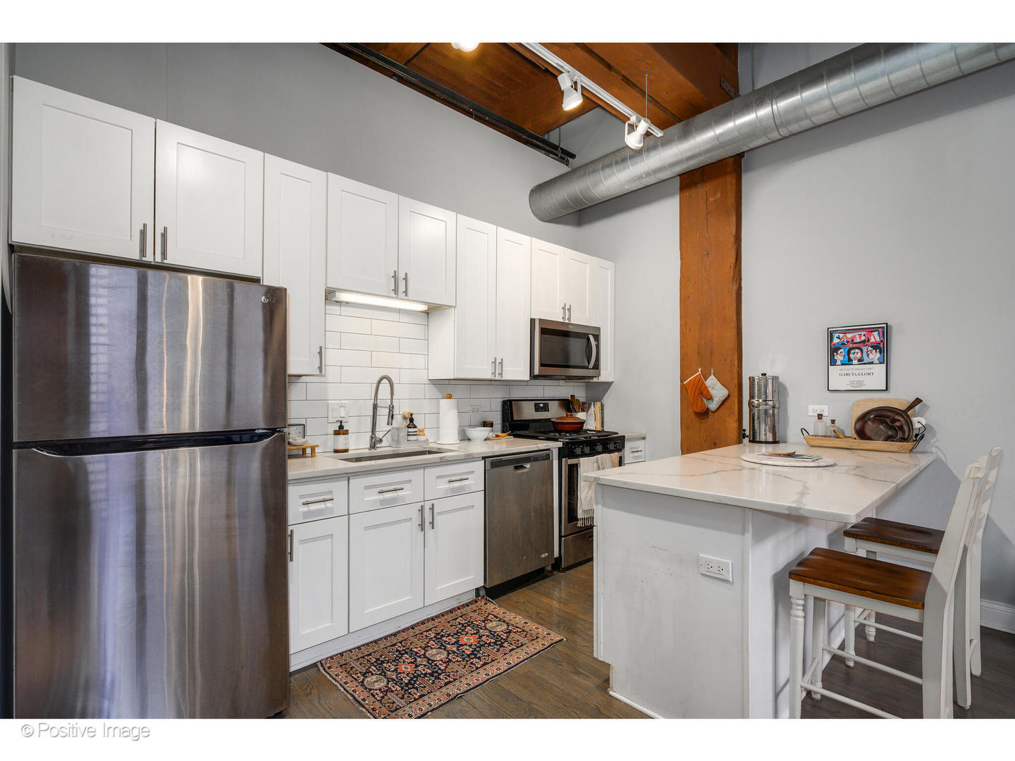 1500 West Monroe Street, Unit 215 Chicago, IL 60607 - Photo 5 of 14 a kitchen with kitchen island a white cabinets and refrigerator