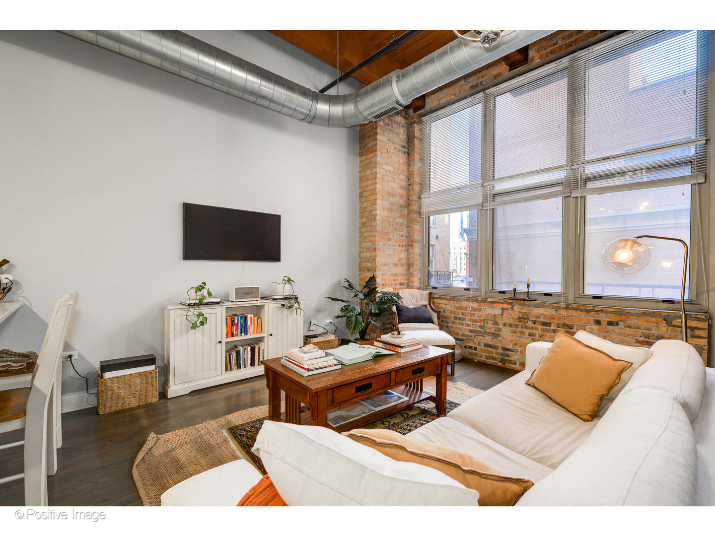1500 West Monroe Street, Unit 215 Chicago, IL 60607 - Photo 6 of 14 a living room with furniture and a flat screen tv