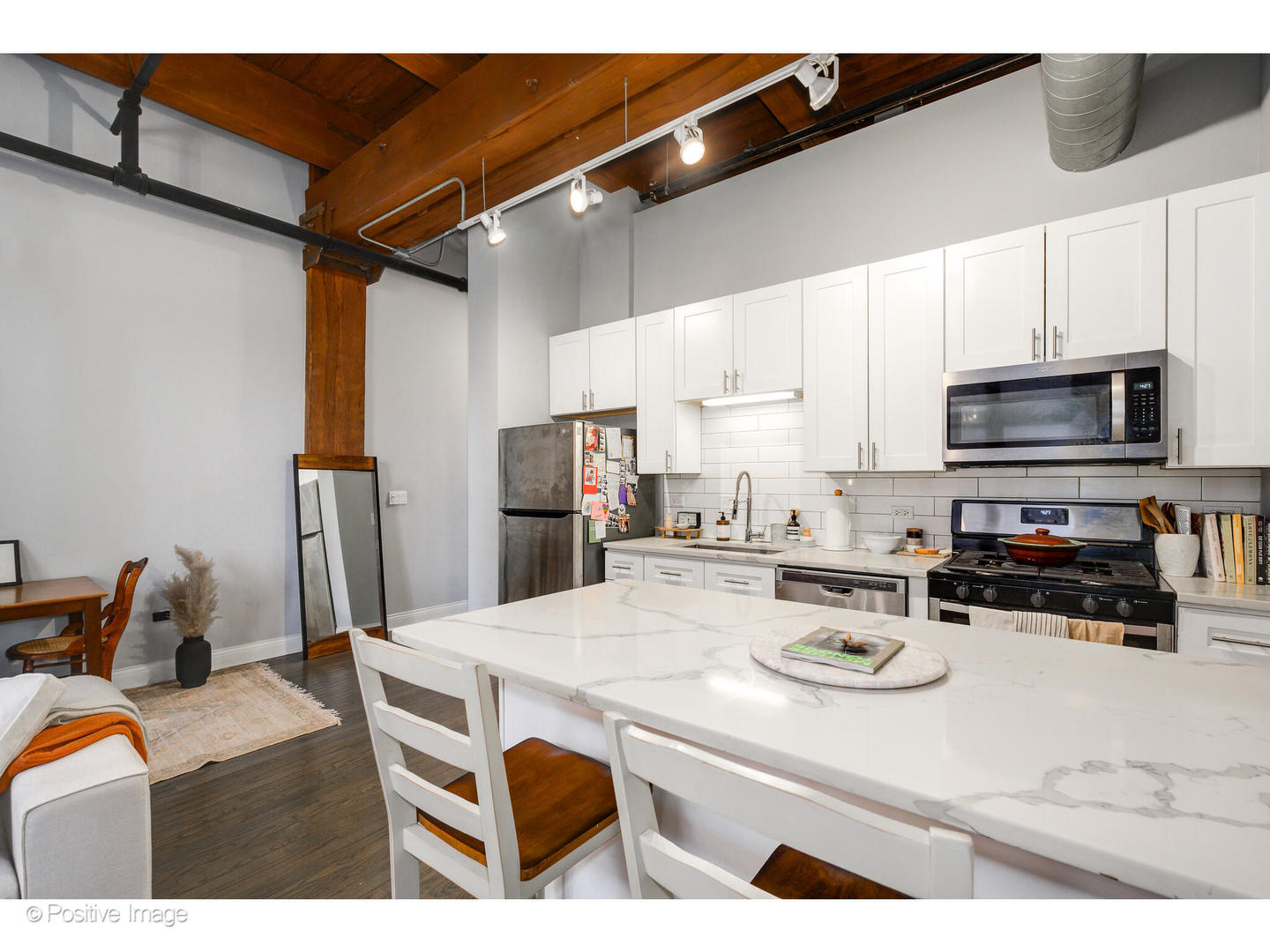 1500 West Monroe Street, Unit 215 Chicago, IL 60607 - Photo 9 of 14 a kitchen with a refrigerator a stove a microwave and cabinets