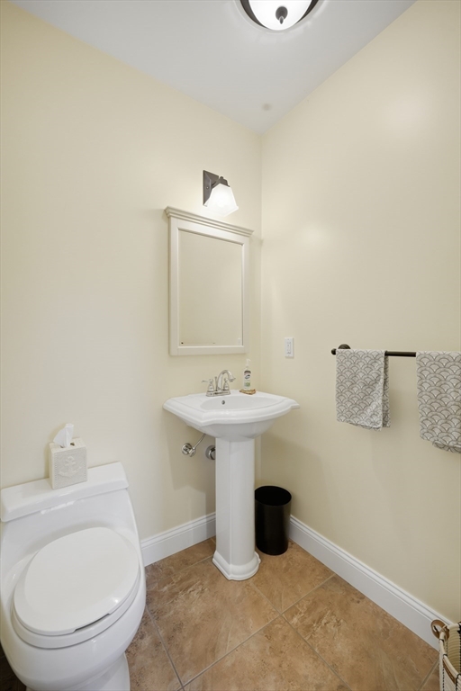 559 East State Street Granby, MA 01033 - Photo 12 of 41 a bathroom with a sink a toilet and mirror