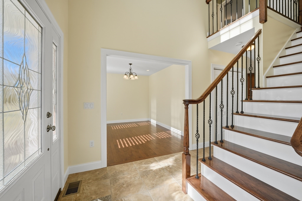 559 East State Street Granby, MA 01033 - Photo 15 of 41 a view of a hallway with wooden floor and staircase