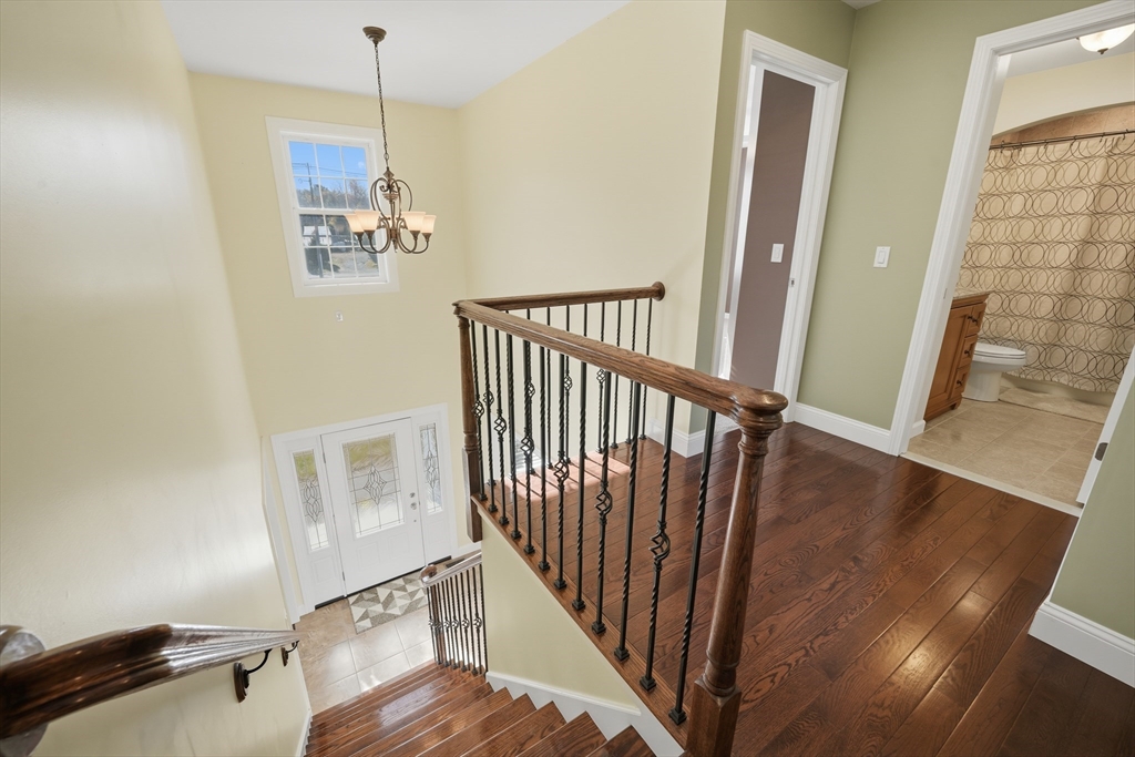 559 East State Street Granby, MA 01033 - Photo 18 of 41 a view of a hallway with wooden floor and staircase