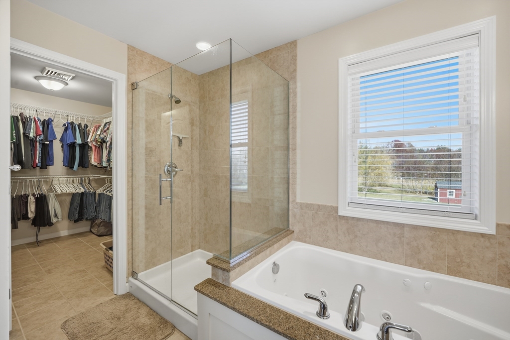559 East State Street Granby, MA 01033 - Photo 23 of 41 a bathroom with a tub a sink and a shower