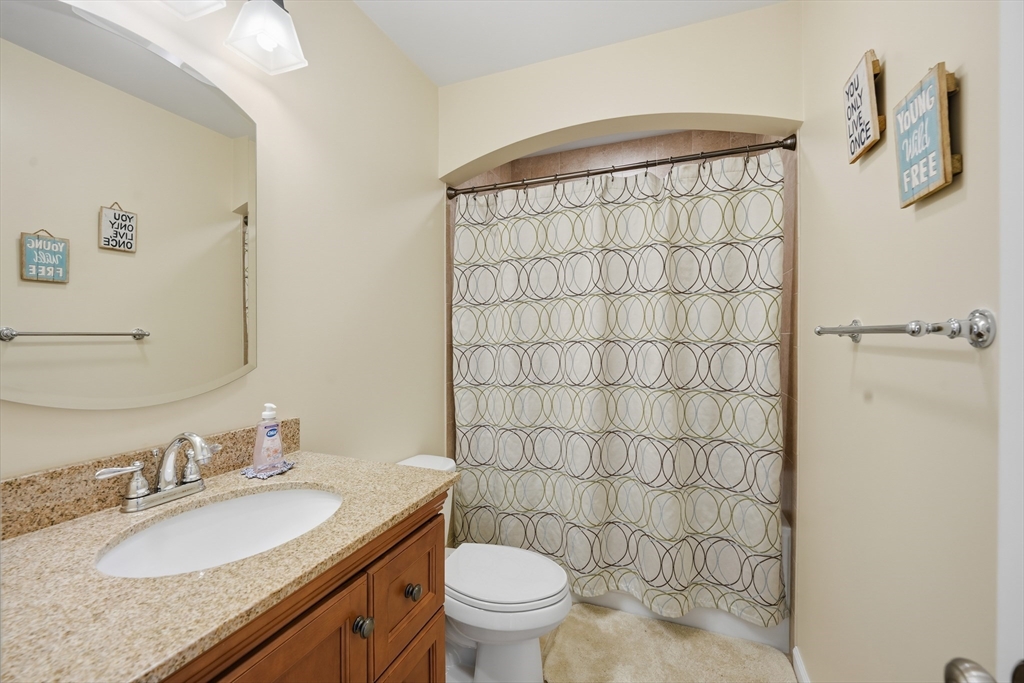 559 East State Street Granby, MA 01033 - Photo 25 of 41 a bathroom with a granite countertop sink toilet and shower
