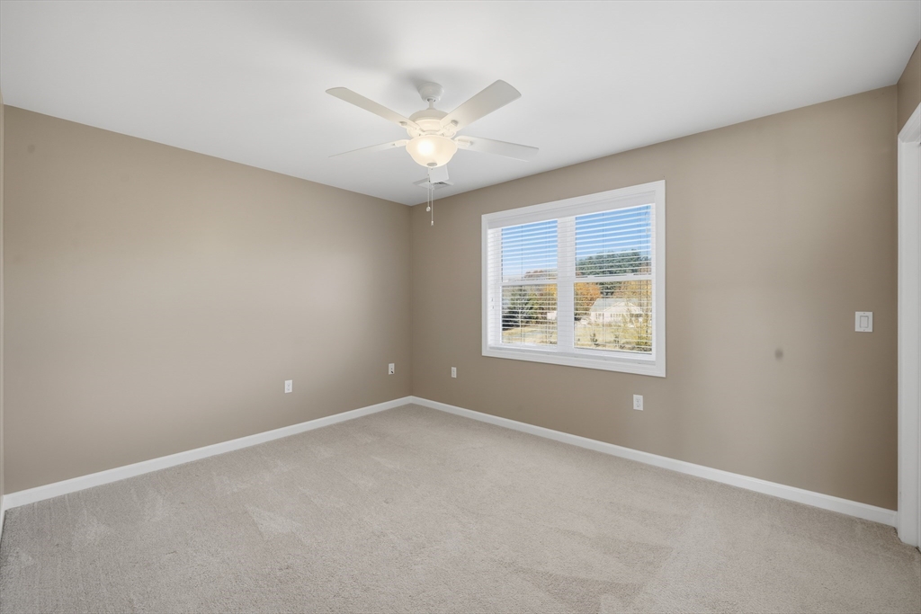 559 East State Street Granby, MA 01033 - Photo 26 of 41 an empty room with a window and a fan