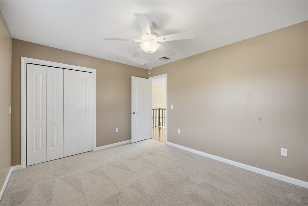 559 East State Street Granby, MA 01033 - Photo 28 of 41 an empty room with a ceiling fan and a window