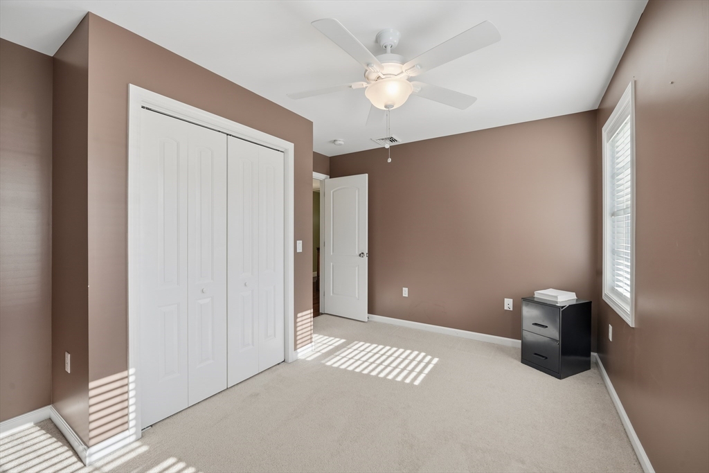 559 East State Street Granby, MA 01033 - Photo 30 of 41 a view of a room with a stylish ceiling fan and entryway