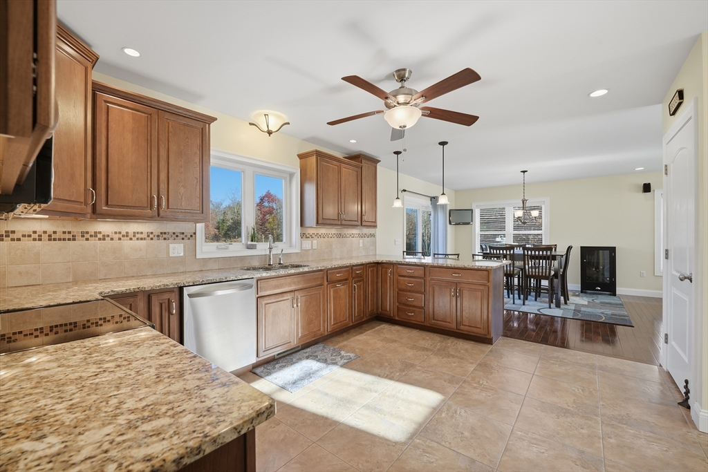 559 East State Street Granby, MA 01033 - Photo 3 of 41 a kitchen with stainless steel appliances kitchen island granite countertop a table chairs sink and cabinets