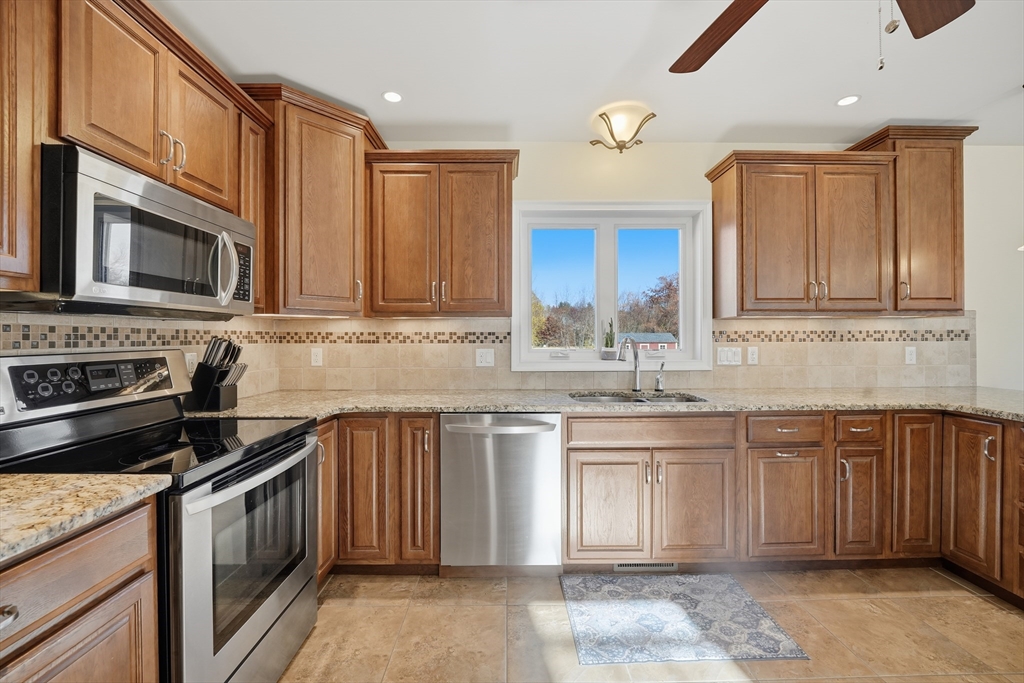 559 East State Street Granby, MA 01033 - Photo 4 of 41 a kitchen with stainless steel appliances granite countertop a stove sink microwave and cabinets
