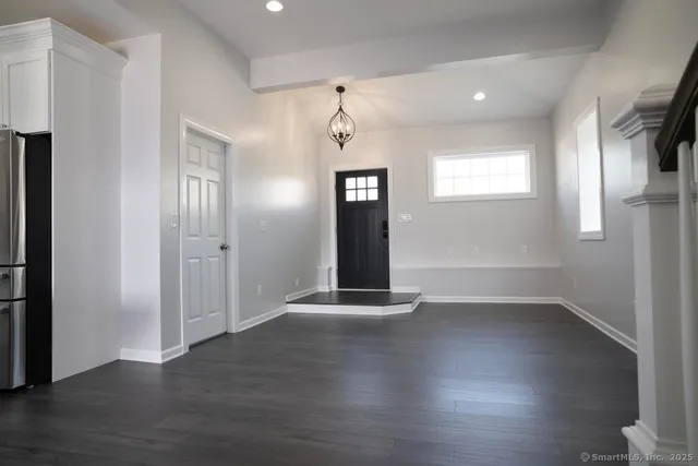 a view of an entryway with wooden floor and stairs