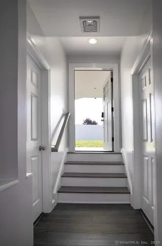 a view of entryway and hall with wooden floor