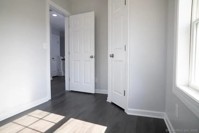 a bathroom with a granite countertop sink mirror vanity and toilet