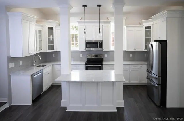 a large kitchen with cabinets and stainless steel appliances