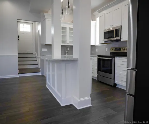 a kitchen with stainless steel appliances a stove top oven and sink
