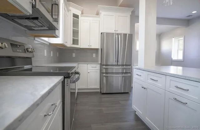 a kitchen with a refrigerator and a sink