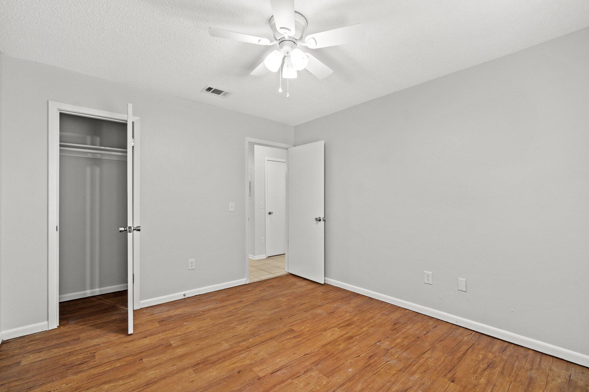 248 4 Mile Road, Unit G Freeport, FL 32439 - Photo 13 of 19 a view of an empty room with wooden floor