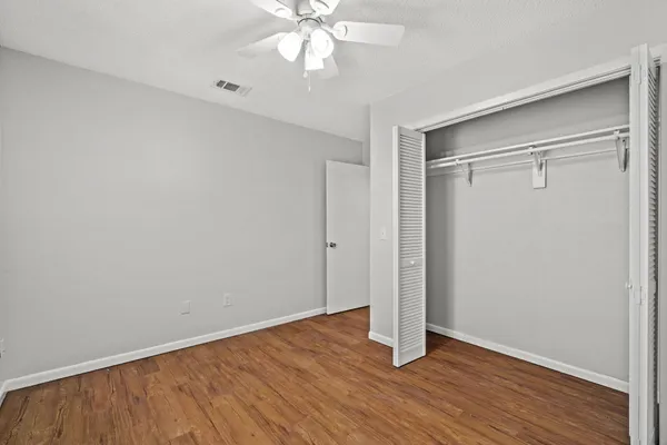 a view of an empty room with wooden floor