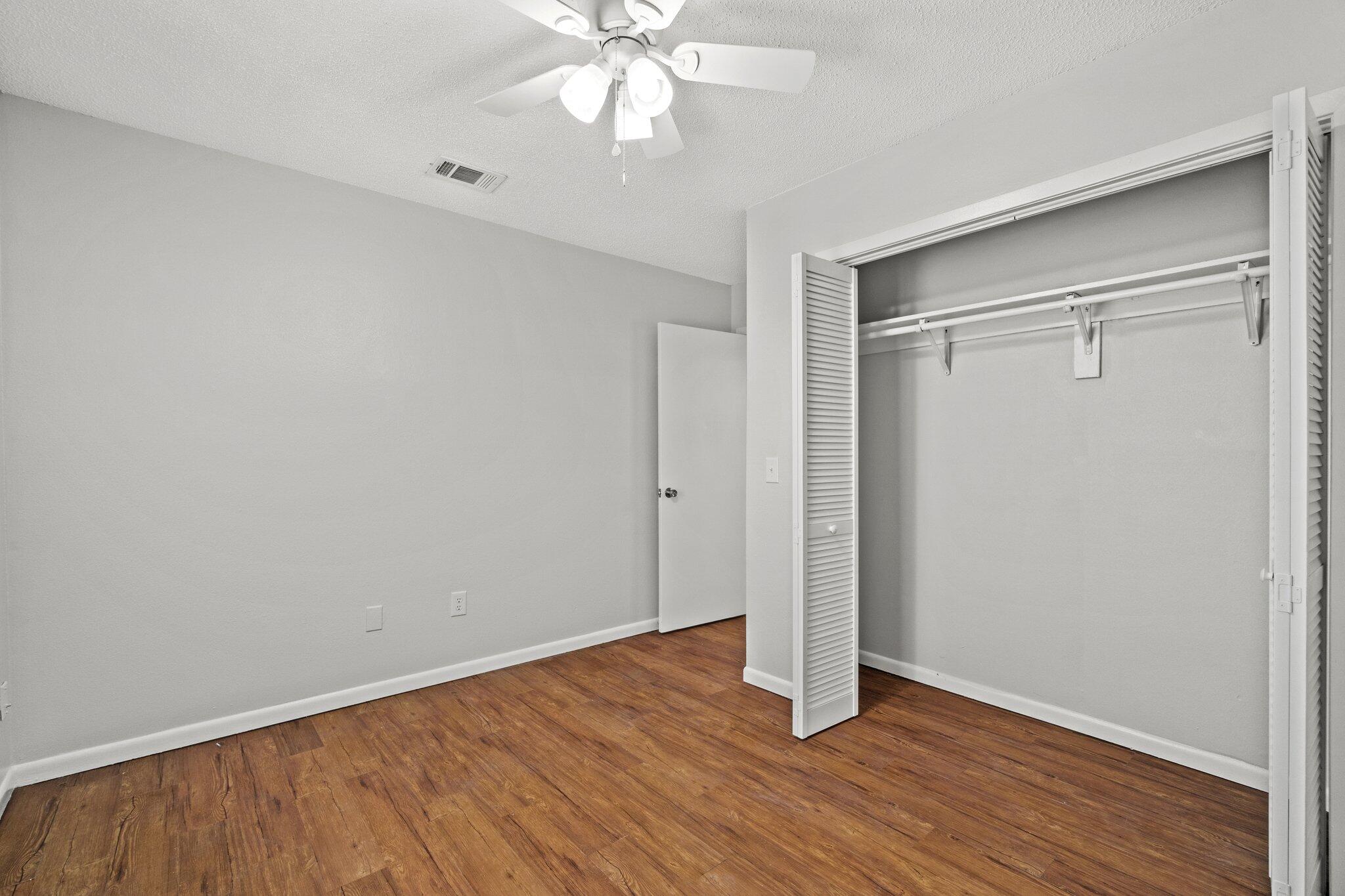 248 4 Mile Road, Unit G Freeport, FL 32439 - Photo 15 of 19 a view of an empty room with wooden floor