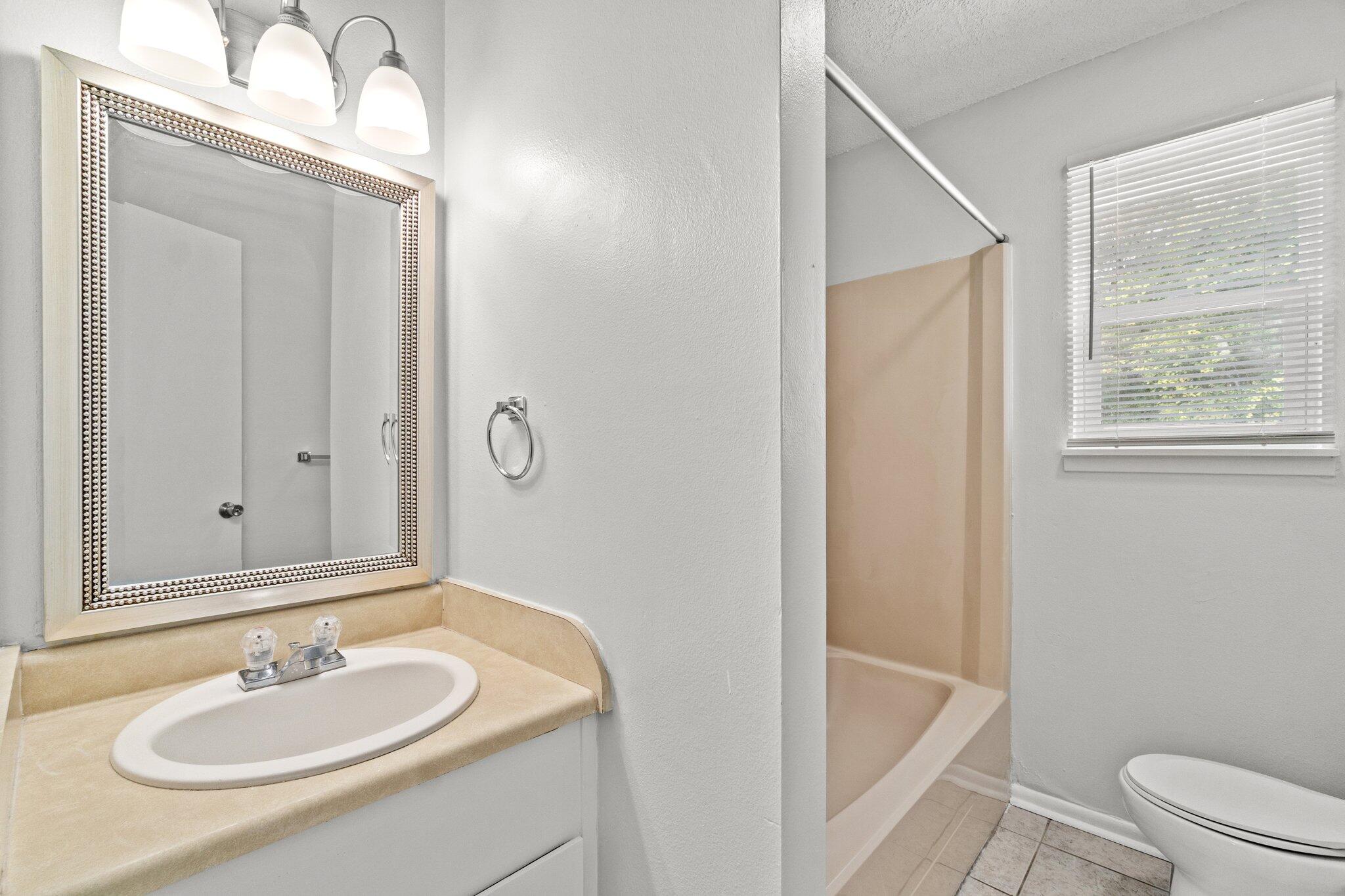 248 4 Mile Road, Unit G Freeport, FL 32439 - Photo 16 of 19 a bathroom with a sink and a mirror