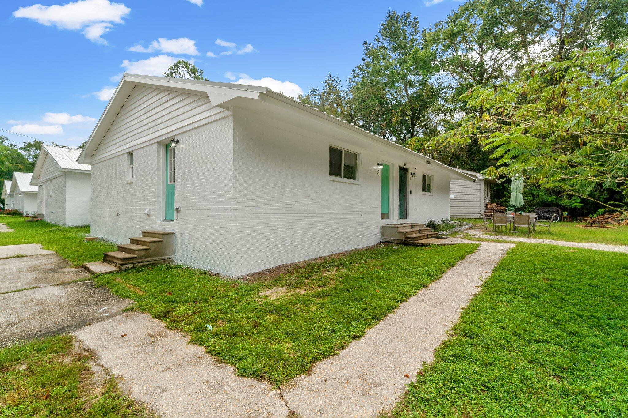 248 4 Mile Road, Unit G Freeport, FL 32439 - Photo 19 of 19 a front view of house with yard and green space