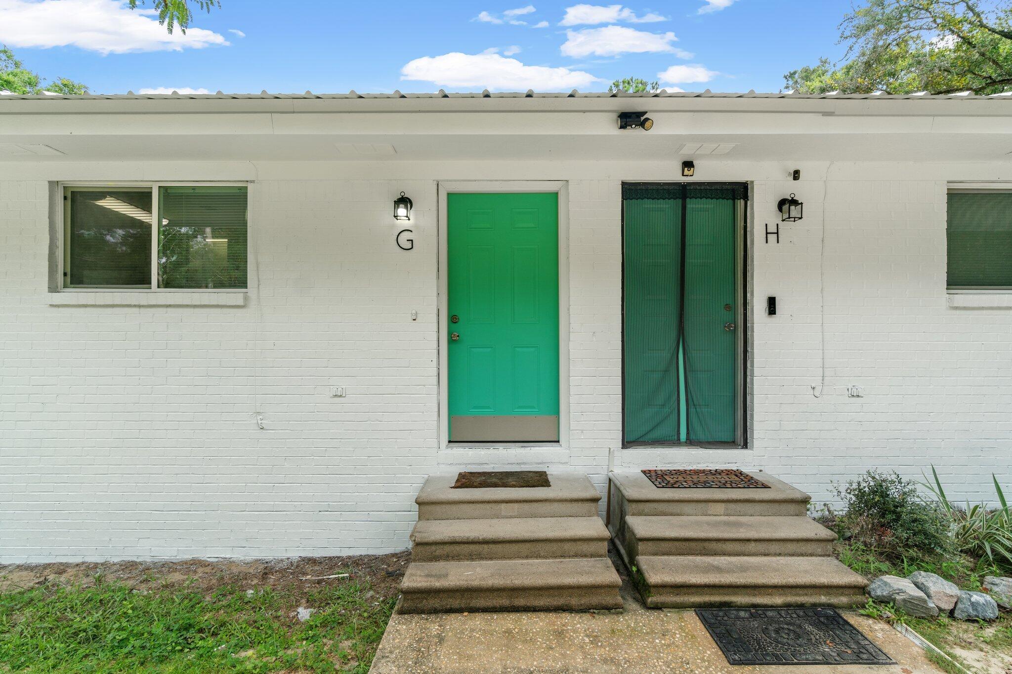 248 4 Mile Road, Unit G Freeport, FL 32439 - Photo 3 of 19 a front view of a house with a garden