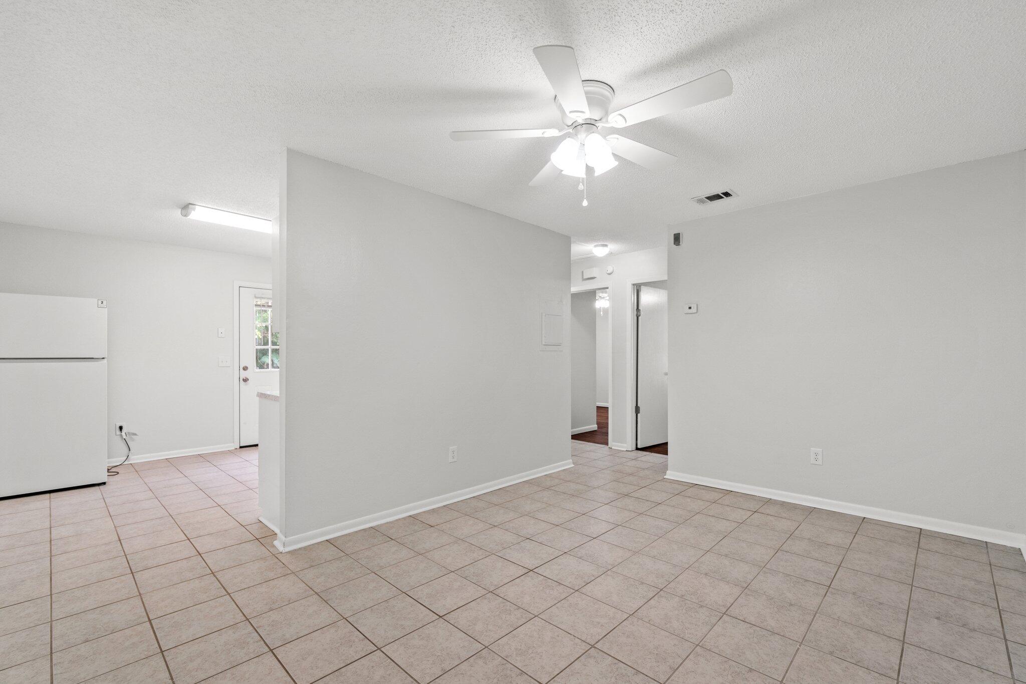 248 4 Mile Road, Unit G Freeport, FL 32439 - Photo 5 of 19 an empty room with fan and way to kitchen