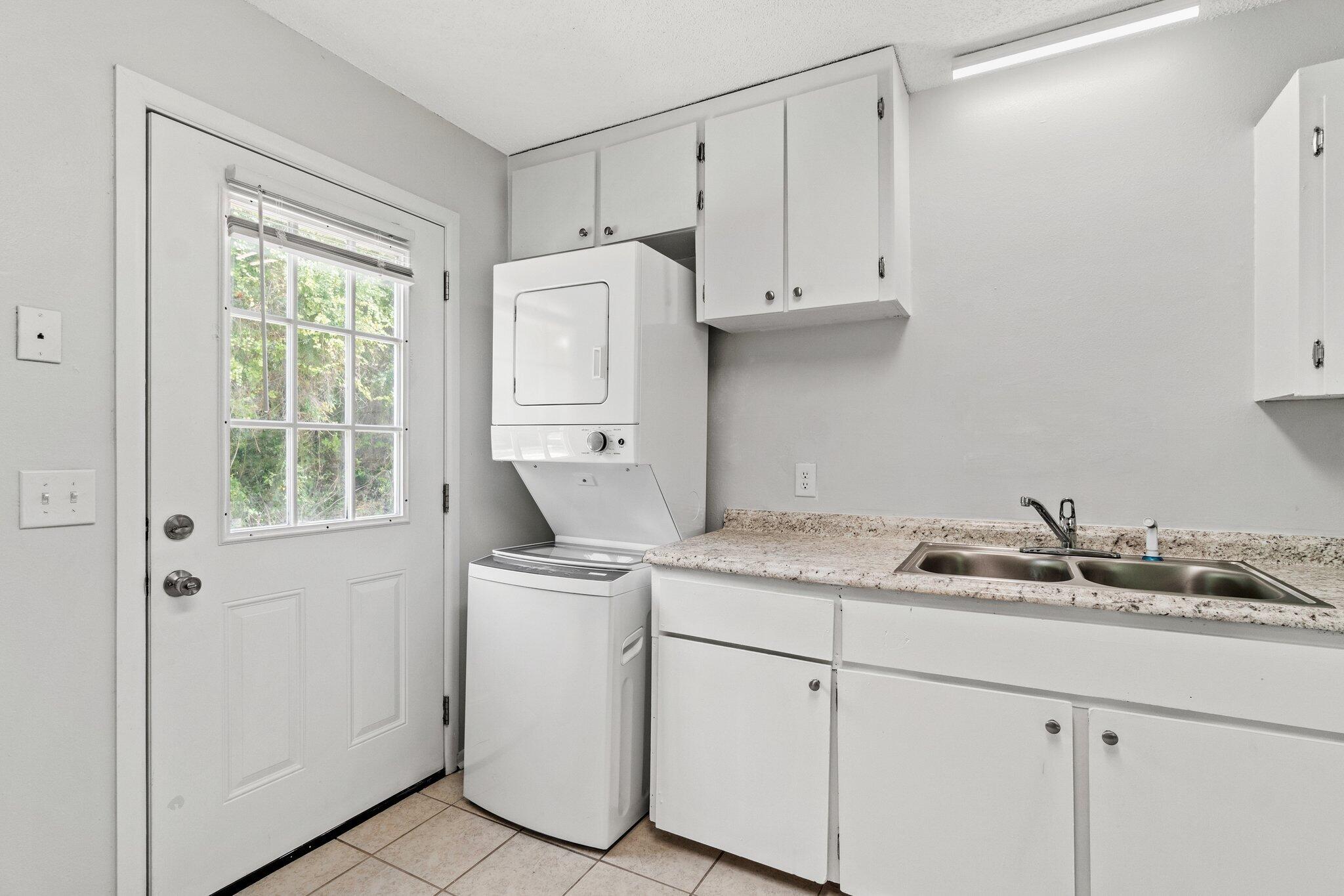 248 4 Mile Road, Unit G Freeport, FL 32439 - Photo 8 of 19 a utility room with cabinets washer and dryer