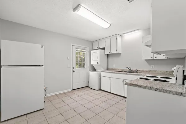 a kitchen with a sink a stove and refrigerator