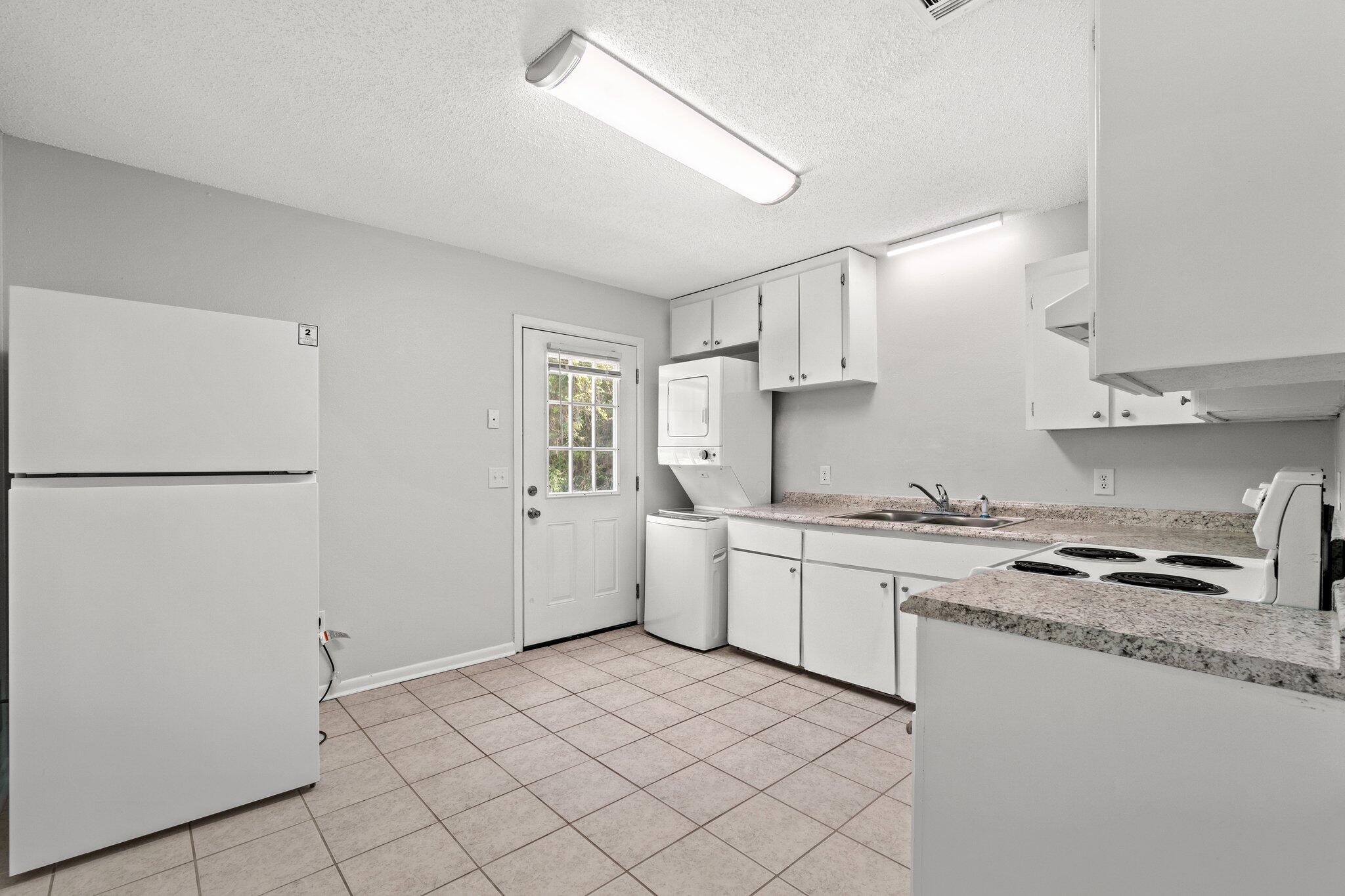 248 4 Mile Road, Unit G Freeport, FL 32439 - Photo 10 of 19 a kitchen with a sink a stove and refrigerator