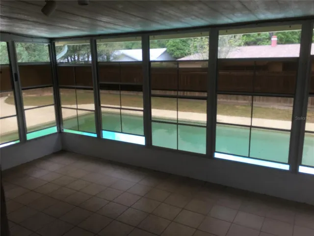 a swimming pool with yard in front of it