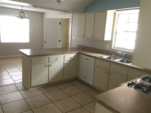 a kitchen with a sink cabinets and window